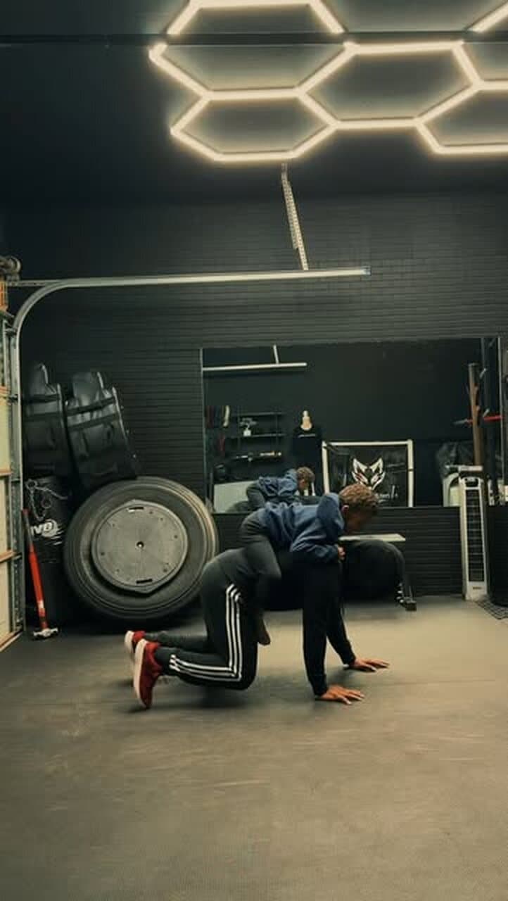 Inside the Method 2 the Madness studio: hex lighting, a tractor tire and two clients training